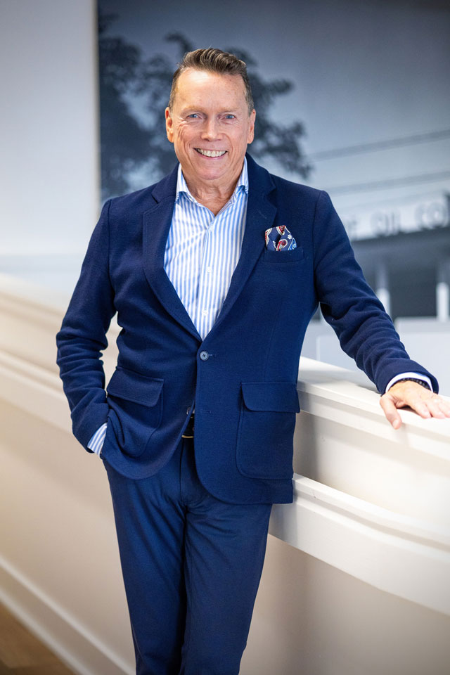 Jeffrey Post standing in a blue suit